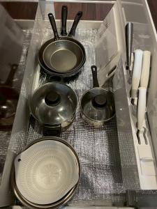 a drawer with three pans and a plate and utensils at 河口湖駅徒歩10分 ベルショッピングセンター徒歩6分 大型4ldk屋根裏付き 全室空調 in Wada
