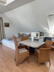 a kitchen and dining room with a table and chairs at Birnbom Warnemünde in Warnemünde