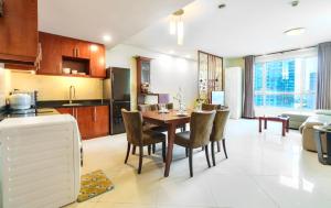 a kitchen and living room with a table and chairs at Premium Suites - Lancaster Building, Saigon-Japanese Town, SG's Heart in Ho Chi Minh City