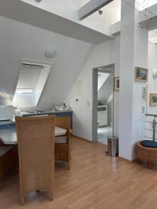 a kitchen and living room with a table and chairs at Birnbom Warnemünde in Warnemünde