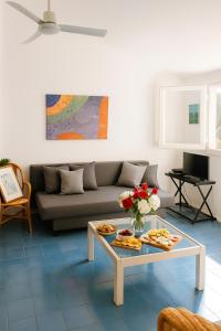 a living room with a couch and a table with food on it at Casa a Calaverde pochi passi dal mare terrazza aria condizionata WiFi e parcheggio in Forte Village