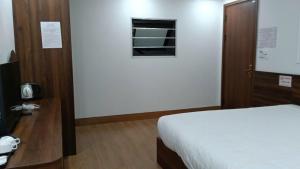 Postel nebo postele na pokoji v ubytování Sapa Warm Hotel