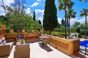 a patio with a table and chairs and trees at FALCO , Apartment auf Finca Zenara, Terrasse, XXL-Pool, Küche, AC, WIFI, Yoga in Manacor