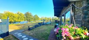 a building with benches and flowers in a park at Lakeview Petting Pod in Chelmsford