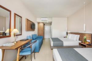 a hotel room with a bed and a desk at Iris Hotel in Siviri