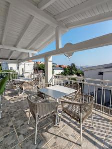 a table and chairs on a patio with a view at Rosemary Resort in Cesarica