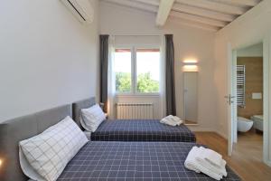 Postel nebo postele na pokoji v ubytování Villa Poggio ai Sassi-Private Villa & Pool + 44 fotografií