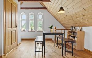 a kitchen with a table and chairs in a room at 7 Bedroom Stunning Home In Grenaa - D70125 in Rimsø