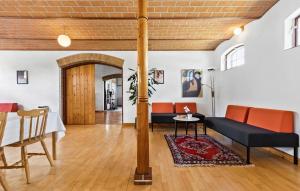 a living room with a table and chairs at 7 Bedroom Stunning Home In Grenaa - D70125 in Rimsø