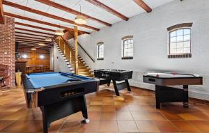 two pool tables in a room with a staircase at 7 Bedroom Stunning Home In Grenaa - D70125 in Rimsø