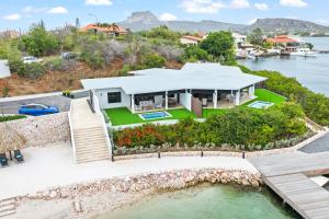 an aerial view of a house on the water at Dolce Vita Beach, Waterfront Bungalows with Private Beach in Willemstad