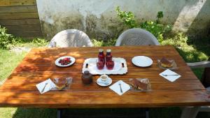 a picnic table with food and drinks on it at Motina River Guesthouse in Tropojë