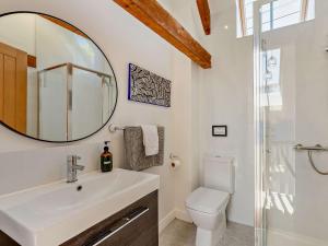 a bathroom with a sink and a mirror and a toilet at 3 Bed in Braunton 53109 in Braunton +18 photos