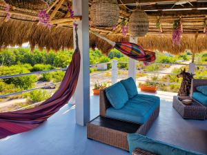 a porch with a hammock and chairs on a resort at Costa Nube in Caye Caulker