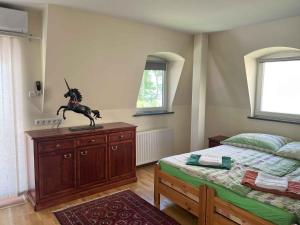a bedroom with a horse statue on top of a dresser at Holiday home in Balatonboglar 48107 in Balatonboglár