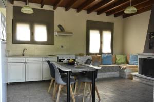 a kitchen with a table and chairs and a couch at Irida in Kato Zakros