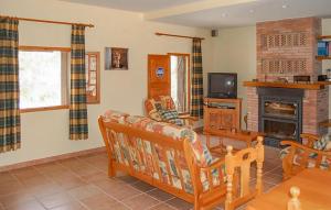 a living room with a couch and a fireplace at 6 Bedroom Cozy Home In Cofrentes - Ebv244 in Cofrentes