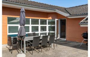 a table and chairs and an umbrella on a patio at Pet Friendly Home In Hejls With Sauna - F04167 in Hejls +11 photos