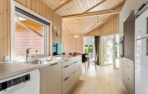 a kitchen with white cabinets and a large window at Pet Friendly Home In Hejls With Sauna - F04167 in Hejls