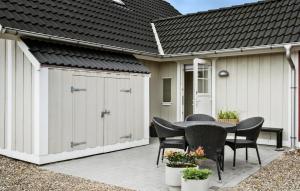 a garage with a table and chairs on a patio at Stunning Home In Brenderup Fyn - G51849 in Bro +32 photos