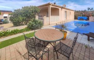 a patio with a table and chairs next to a pool at Nice Home In Cessenon Sur Orb - Flh677 in Cessenon