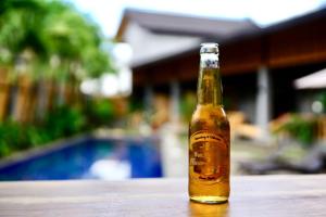 a bottle of beer sitting on a table at Mayfair Garden Resort in Panglao Island