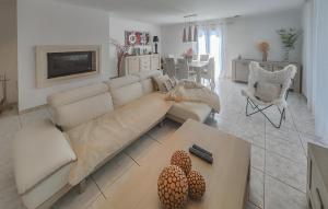 a living room with a couch and a table at Nice Home In Cessenon Sur Orb - Flh677 in Cessenon