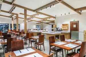 a dining room with wooden tables and chairs at Iris Hotel in Siviri