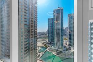 two views of a city skyline with tall buildings at Modern Studio In Jlt Cluster L Top Facilities in Dubai
