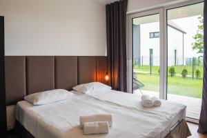 a bedroom with a bed with two towels on it at Moje Miejsce Polanica-Zdrój in Polanica-Zdrój +32 photos