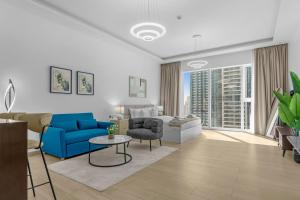 a living room with a blue couch and a blue chair at Modern Studio In Jlt Cluster L Top Facilities in Dubai