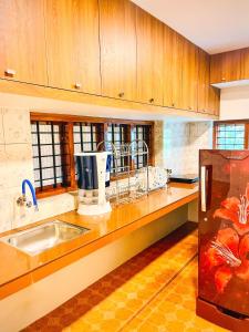 a kitchen with a sink and a counter top at Executive Room in Kelakam
