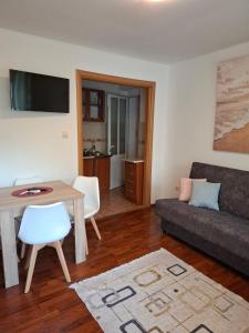 a living room with a couch and a table at Apartmani Ljumović Budva in Budva