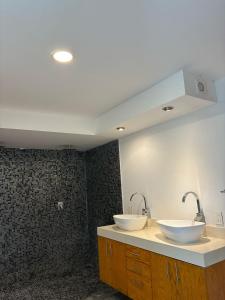 a bathroom with two sinks on a counter at Live the Beach Life Luxury, Location and Total Comfort in Playa del Carmen