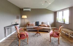 a living room with a couch and a table and chairs at 2 Bedroom Beautiful Home In Fleninge - S12280 in Fleninge