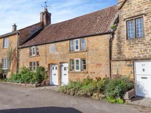 an old brick house with white doors and windows at 1 Bed in Montacute 93149 in Montacute