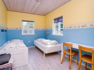 a room with two beds and a table and chairs at 9 person holiday home in Jægerspris-By Traum in Jægerspris