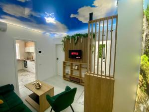 a living room with a couch and a tv on a ceiling at Ilie Petre Luxury Suites in Chiajna
