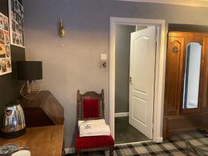 a room with a chair and a desk and a door at The Old Mill Inn in Dyke +45 photos