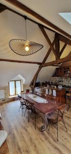 een eetkamer met een grote tafel en stoelen bij Les Granges Indigo in Fossemagne