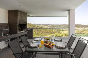 a dining room with a table with food on it at Lux House in Leiria