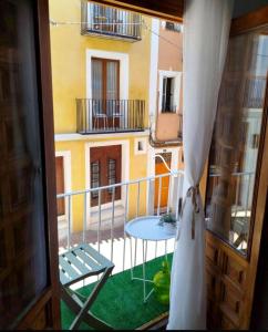 a view of a balcony with a table and a building at Casita de Pescadores en La Costera in Villajoyosa