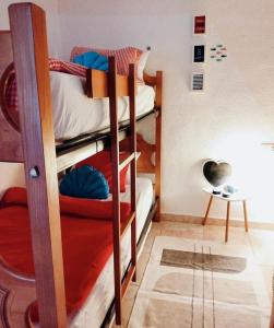 a room with three bunk beds in a room at Casita de Pescadores en La Costera in Villajoyosa