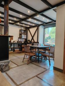 a dining room with a table and chairs at Casas Viejas de Rauco, casa patrimonial en el campo in Curicó