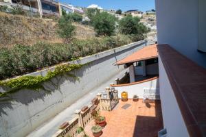 a balcony with benches and plants on a building at Appartamento SCICK in Crotone