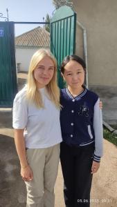 two girls are standing next to each other at Bayel Guest house in Kochkorka