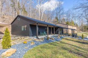 a home with a black house with a yard at Secluded Cabin w/ Hot tub near French Lick, IN in French Lick