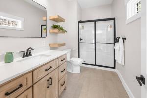 a bathroom with a toilet and a sink and a shower at Secluded Cabin w/ Hot tub near French Lick, IN in French Lick +32 photos