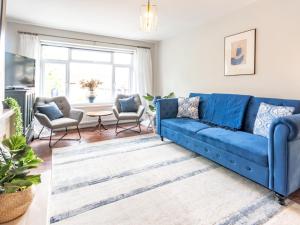 a living room with a blue couch and chairs at Stylish 2-Bedroom Flat in Great Warley – Sleeps 6 Pass the Keys in Great Warley Street