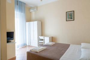 Postel nebo postele na pokoji v ubytování Hotel Miramare